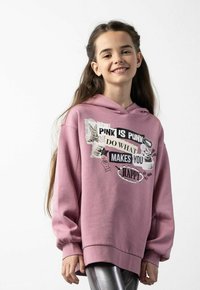 Różowa bluza z luźnym krojem, z grafiką tekstu i ilustracjami w czerni i bieli. Miękka tkanina, ściągacze na rękawach i u dołu.