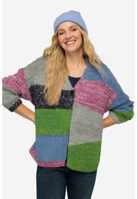 Monivärinen neulecardigan, jossa on suuret tikkaukset harmaassa, vaaleanpunaisessa, vihreässä, sinisessä ja laivastonsinisessä. Ominaisuuksina leveät hihat ja yksi napin kiinnitys.