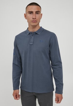 Langermet polo skjorte i mørkeblå bomull, med kragehals, to-knaps placket og brodert logo på brystet. Strukturert stoff.
