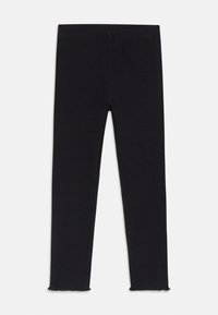 Leggings noirs avec une texture côtelée, une taille haute et des ourlets à coupe brute. Fabriqués à partir d'un matériau extensible pour le confort et la flexibilité.