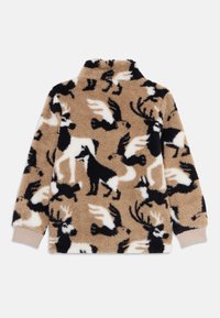 Ullent beige genser med svarte og hvite dyresilhuetter, inkludert hjort, fugler og ulver, med ribbestrikkede beige mansjetter, lagt flatt.