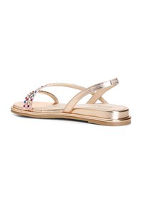 Sandali flat dorati con più cinturini decorati da rhinestones colorati. La suola è piatta e con una finitura metallica liscia.