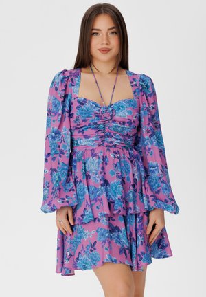 Floral dress featuring a pink base with blue and purple flower patterns, puffed sleeves, a fitted bodice, and a flared skirt.