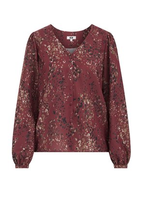 Blouse bordeaux à manches longues, décolleté en V, boutons sur le devant, et un motif à pois dans des tons dorés, noirs et crème, fabriquée en tissu doux.