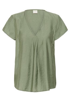 Short-sleeve top in soft, light green fabric with a V-neck and pleating detail at the front. Smooth texture, slightly loose fit, and asymmetrical hem.