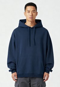 Felpa cappuccio blu navy con tasca a marsupio, polsini e orlo a coste. Realizzata in un morbido tessuto testurizzato. Vestibilità rilassata, maniche lunghe.