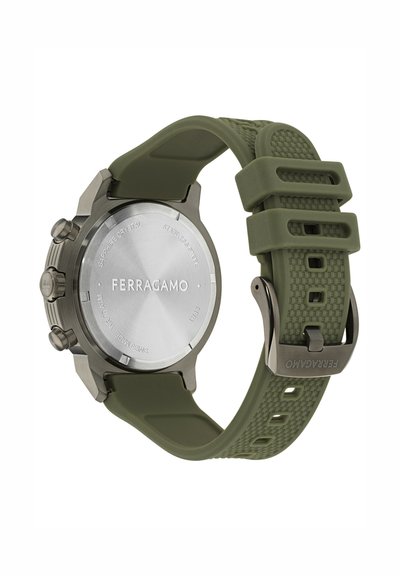 Grüne Silikonarmbanduhr mit einem Gehäuse aus Edelstahl, Saphirglas und graviertem Rücken, ausgestattet mit drei Drückern und einem strukturierten Armband.