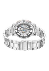 Silverfärgad armbandsur i rostfritt stål med en transparent baksida som visar den intrikata rörelsen. Utrustad med en polerad armband och en markerad bezel.