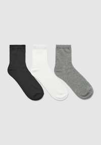 Tre paia di calzini a crew in nero, bianco e grigio mélange, realizzati in materiale morbido ed elastico con una texture liscia e polsini a costine.