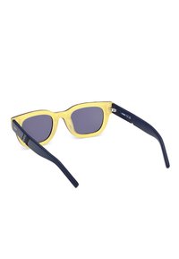 Gafas de sol con un marco amarillo transparente y lentes gris oscuro. Cuentan con varillas azul marino con grabado sutil y un diseño elegante.