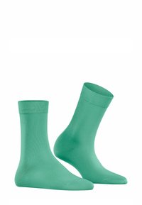 Türkise Knöchelsocken aus glattem, dehnbarem Stoff mit einem gerippten Bündchen. Sie verfügen über eine einfarbige Gestaltung und ein elegantes, nahtloses Design.