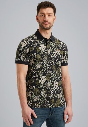 Poloshirt met korte mouwen in een zwarte basis met groene en beige bloemenpatronen, een zwarte kraag en een subtiele logo-detail op de borst.