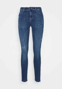 Jeans ajustados de denim en azul oscuro con un ligero efecto desgastado. Presentan un diseño tradicional de cinco bolsillos y un cierre con botón oculto.