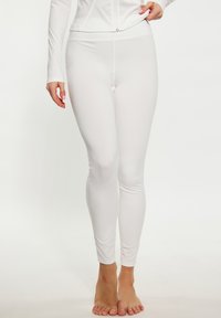 Witte leggings gemaakt van een glad, elastisch materiaal. Heeft een strakke pasvorm met een hoge tailleband, ideaal voor sportieve kleding.