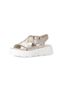 Metallic gold platform sandals with wide crisscross straps, adjustable buckle, and a chunky white rubber sole. Textured surface.