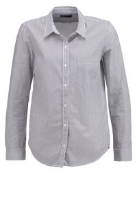 Chemise à manches longues rayée bleu marine et blanche, dotée d'un col boutonné, d'une poche avant et d'une fermeture à boutons avec poignets. Matière en coton.