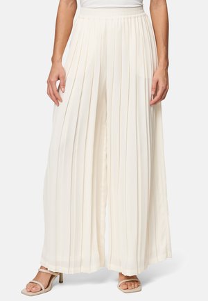 Pantaloni plissettati a gamba larga color crema con cintura elastica. Realizzati in un tessuto leggero. Caratterizzati da una consistenza morbida e fluida e un ottimo drappeggio.