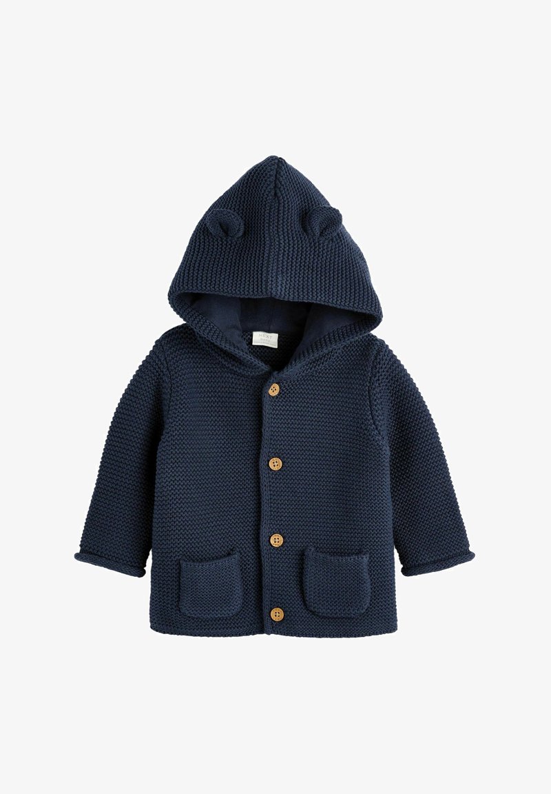 Cardigan bébé tricoté bleu marine avec capuche, petites oreilles d’ours, boutons en bois sur le devant et deux poches devant.