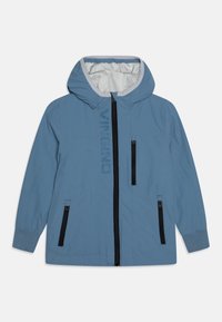 Light blue jacket with a hood, black zipper, and two zippered side pockets. Features a subtle logo along the front and elastic cuffs.