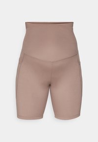 Hoch taillierte Fahrradhosen in einem einfarbigen Taupe-Ton, hergestellt aus glattem, elastischem Stoff mit Seitentaschen und Flatlock-Nähten für hohen Tragekomfort.