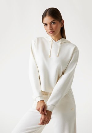 Witte hoodie met textuurpatroon, trekkoord en geribde manchetten, gecombineerd met bijpassende witte broek met een subtiele logodetail.