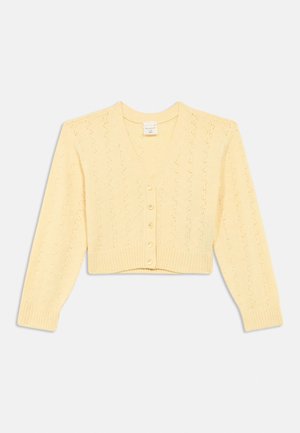 Lysegul strikket cropped cardigan med lange ærmer, V-udskæring, delikat hulmønster, ribbet kant og fem perleagtige knapper ned foran.
