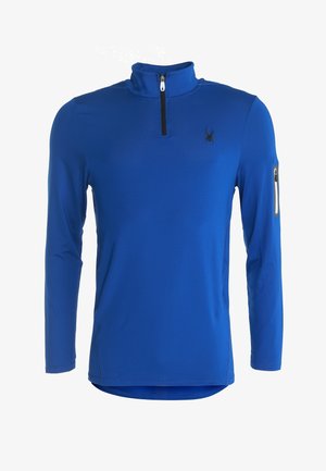 Sudadera azul de manga larga con media cremallera, fabricada con un tejido texturizado, contorno que realza la silueta y un pequeño bolsillo con cremallera en la manga izquierda.