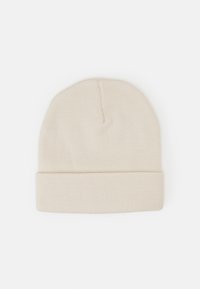 Knit beanie hat in off-white, featuring a rolled brim, smooth texture, and a simple design, suitable for various casual looks.