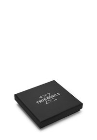 Sort firkantet emballage med en glat mat finish. Har hvidt trykt tekst med teksten "TRUE REBELS" og dekorative accenter.