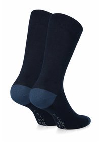 Granatowe skarpetki o gładkiej fakturze; ciemniejsze akcenty na pięcie i palcach; ściągacz na górze; stonowane logo po boku.