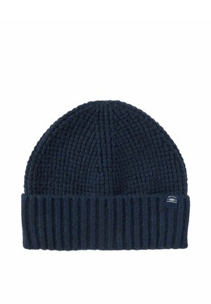 Gorro de lana azul marino con puño acanalado doblado y pequeña etiqueta de tela con marca en el lateral.