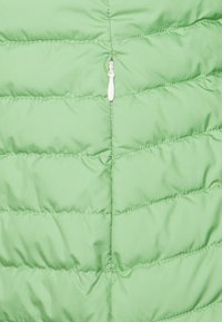 Green puffer jacket featuring a quilted design with horizontal stripes, a central zipper, and a smooth, lightweight fabric texture.
