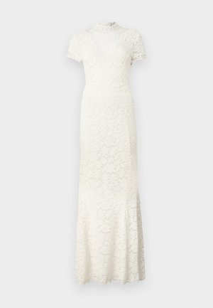 Rochie din dantelă în nuanță de ivoriu, cu mâneci scurte, un guler înalt și modele florale intricate. Fuste evazată cu margini zimțate.