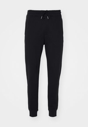 Black sweatpants made of soft fabric, featuring an elastic waistband with drawstring, side pockets, and tapered cuffs at the ankles.