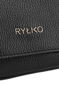 Black leather bag close-up with a textured surface, featuring a gold-tone logo reading "RYŁKO." Note the stitched edges and smooth finish.