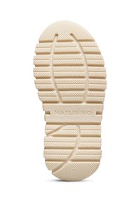 Suela de zapato de goma blanca con patrones texturizados, que presenta surcos para agarre y la marca "NATURINO" grabada en el centro.