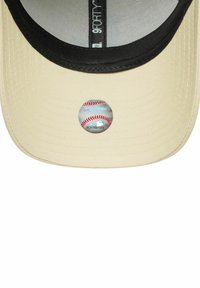 Beige Baseballcap mit einem schwarzen Schirm, der ein rundes Logo zeigt, das einen Baseball auf der Unterseite des Schirms darstellt. Strukturierter Krondstoff.