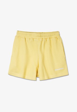 Yellow ribbed shorts with an elastic waistband, featuring side pockets and a white logo on the lower right side. Soft texture.