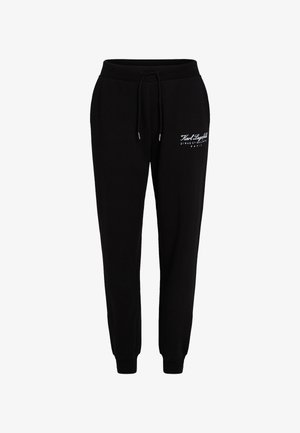 Sorte sweatpants lavet af blødt stof med elastisk talje og snøre, tætsiddende ben og hvidt trykt logo på forsiden.