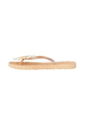 Beige woven thong sandal with textured sole and a white flower decoration on the strap above the toes.