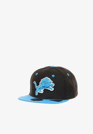 Black and blue baseball cap with a blue lion logo embroidered on the front and blue eyelets on top.