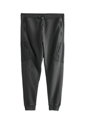 Dunkelgraue Sweatpants aus weichem Stoff mit zulaufenden Beinen, elastischem Bund und mehreren seitlichen Reißverschlusstaschen.