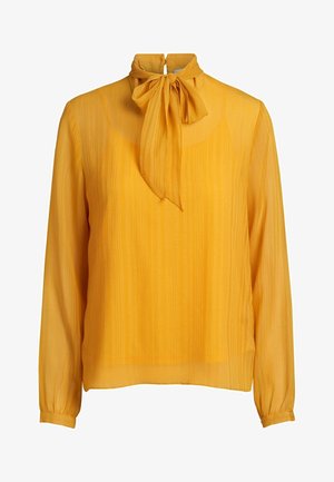 Gelbe Bluse mit langen Ärmeln aus durchscheinendem Material und strukturiertem Streifenmuster, mit einem hohen Kragen und einer Schleifen-Detail am Ausschnitt.