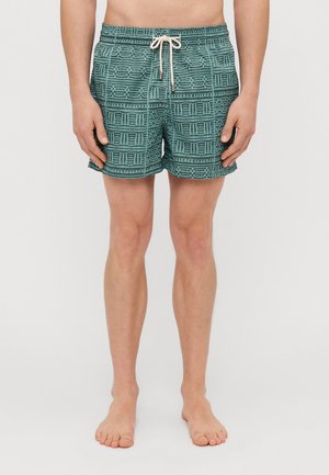 Costume de baie scurt în nuanță de teal, cu un model geometric complicat. Are o talie elastică și un șnur în față. Material ușor.