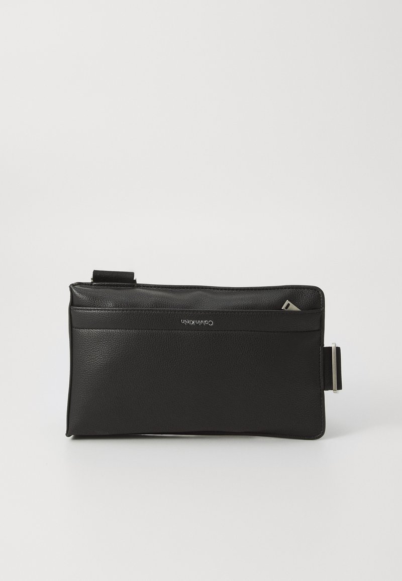 Black leather clutch bag with a smooth texture, features a zip closure, a front pocket, and an adjustable strap. Minimalistic design.