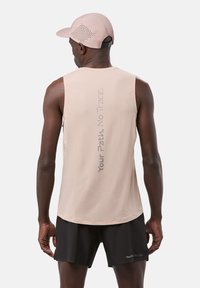 Light pink sleeveless athletic top featuring a grid texture and vertical graphic text on the back, paired with black shorts.