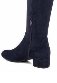 Navy blue suede ankle boot with a round toe, side zipper detail, and a low block heel. Smooth texture with no visible patterns or accents.