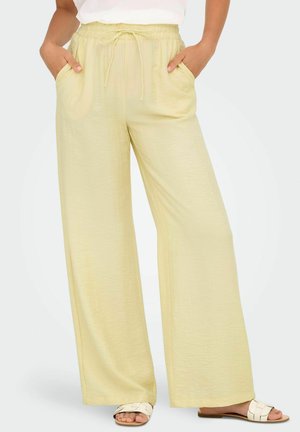 Helle gelbe, weit geschnittene Hose mit einem elastischen Bund und Kordelzug. Verfügt über seitliche Taschen und einen weichen, strukturierten Stoff.