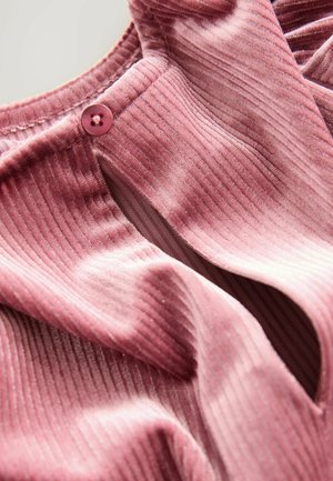 Pink ribbed fabric with a slightly shiny texture. Features a cutout neckline and a pink button closure at the shoulder.