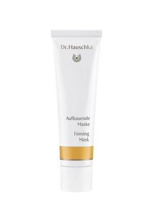 Weiße Röhrenverpackung mit einem goldenen Akzentband. Enthält den Produktnamen "Firming Mask" und "Aufbauende Maske" in klarer Schrift. Dr. Hauschka Logo vorhanden.